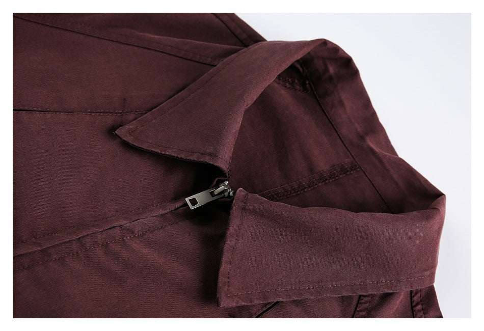 Close-up of the burgundy jacket's collar, stitching and metal zipper detail.