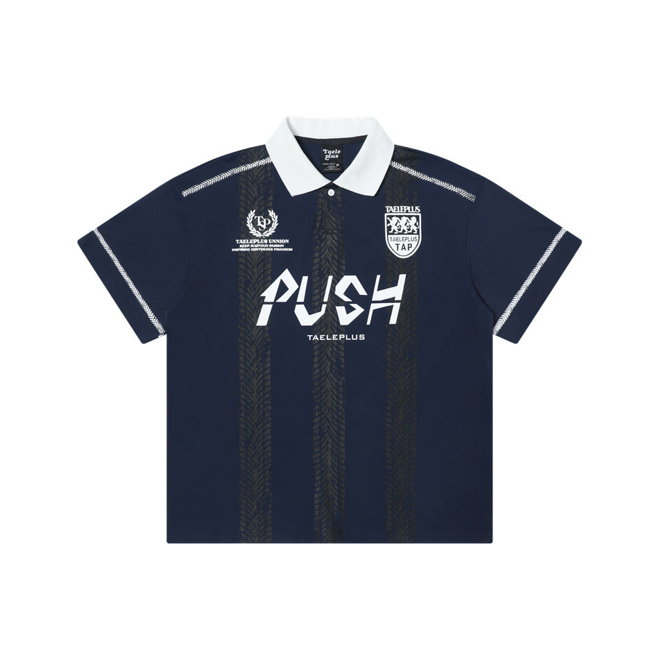 Navy blue short-sleeve polo jersey with white collar, white stitching, tire-tread stripes and white PUSH graphic, front flat