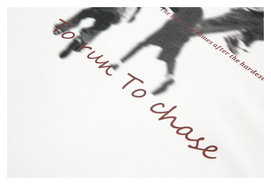 Close-up of blurred dark figures and large reddish script lettering printed on off-white fabric.