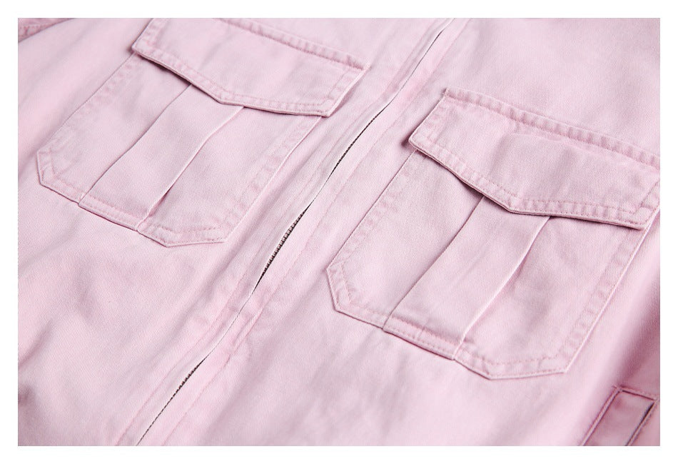 Close-up of a pale pink jacket front with two flap chest pockets and a central zipper.