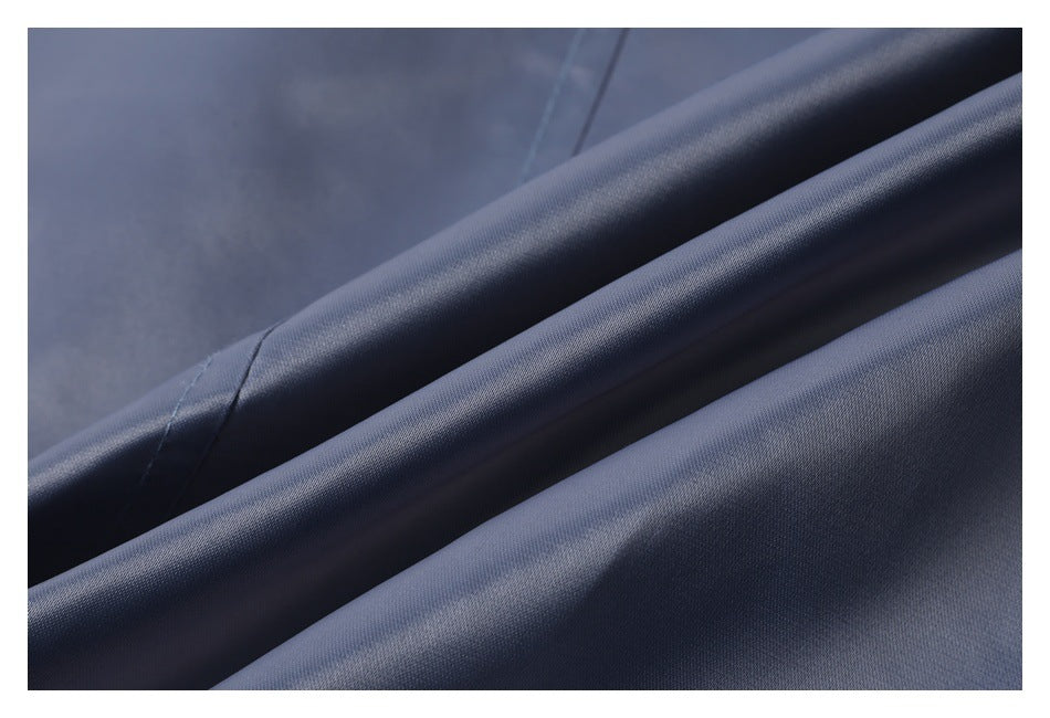 Close-up of smooth blue-gray fabric arranged in soft folds.