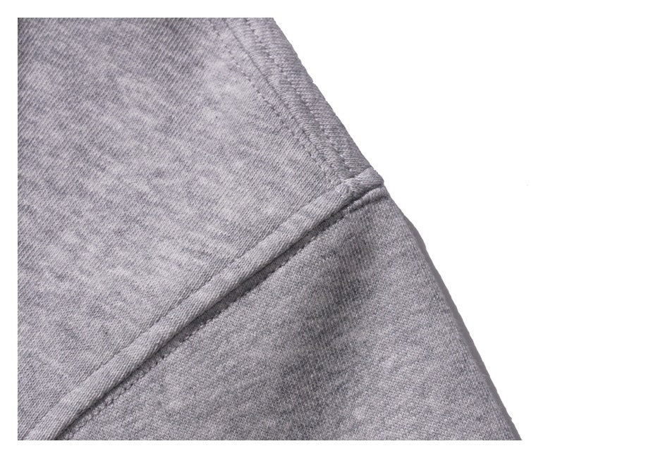 Close-up of a gray sweatshirt seam and stitching.