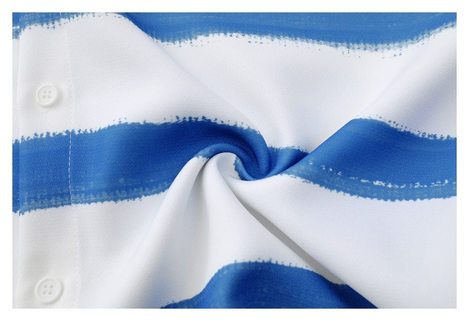 Close-up of the white shirt fabric gathered to show its blue brushstroke stripe pattern and buttons.