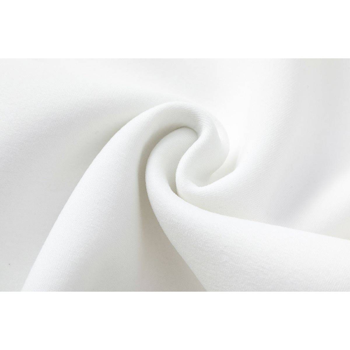 Close-up of smooth white fabric folded into a soft twist.