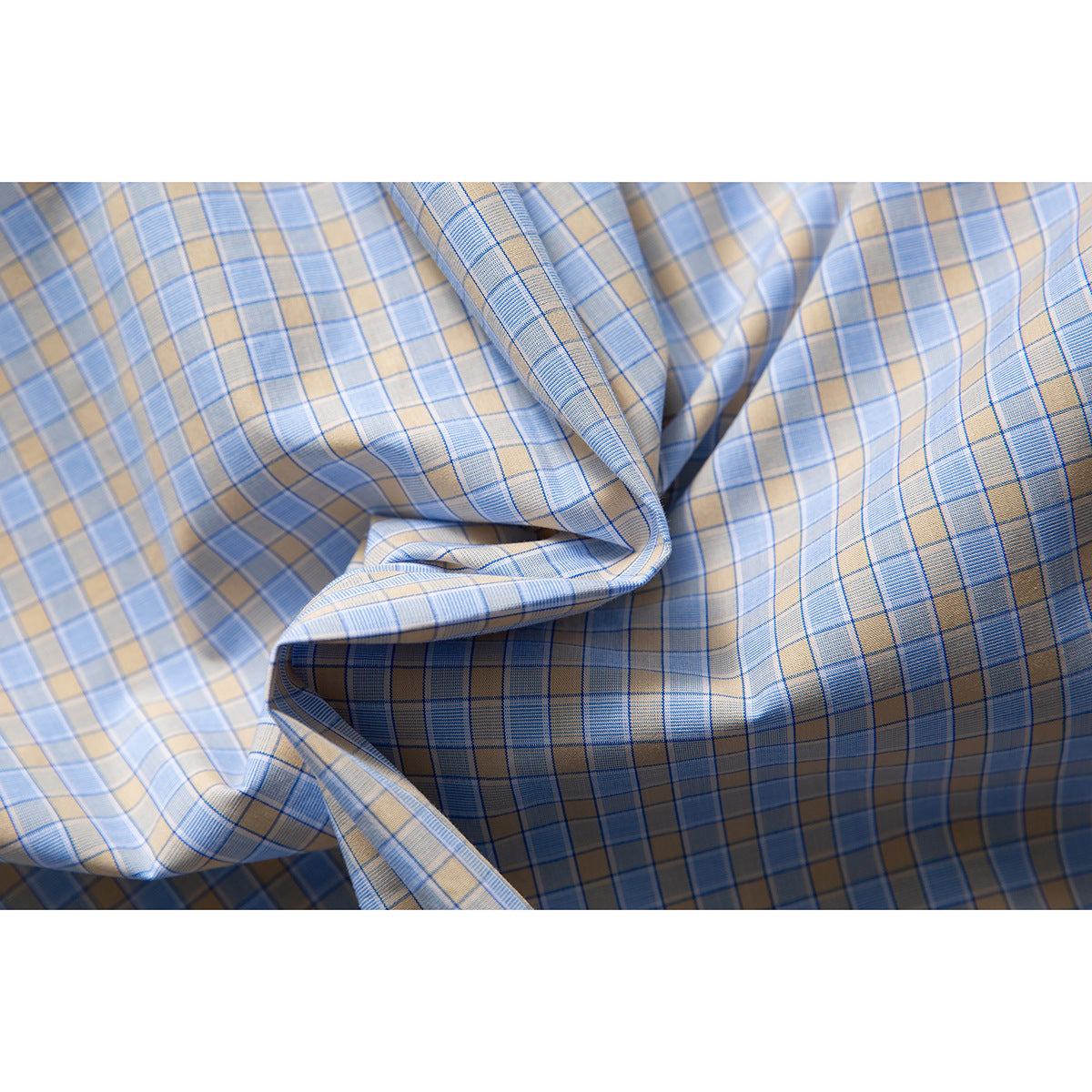 Light blue and beige plaid shirt fabric shown in folded drapes, highlighting its check pattern.