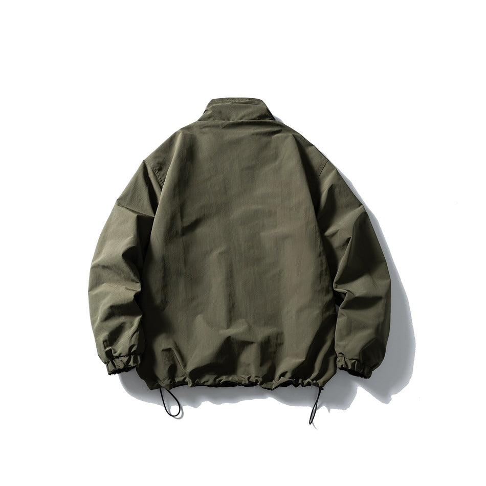 Back view of an olive jacket with a stand collar, gathered cuffs, and adjustable hem drawcords.