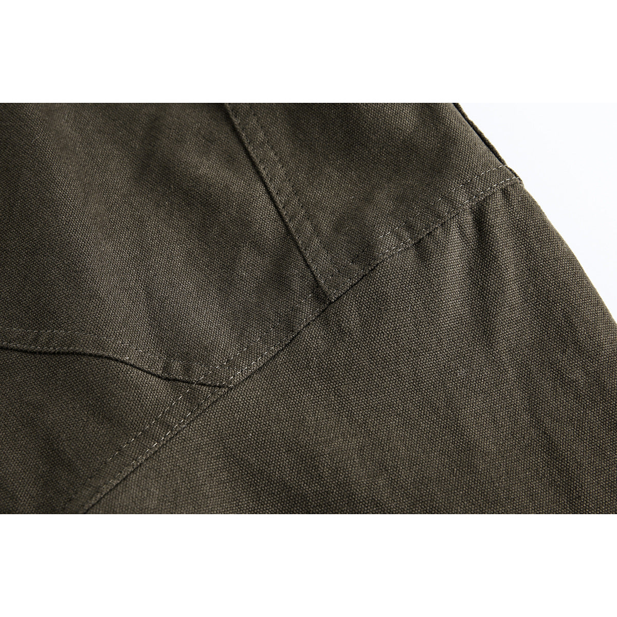 Close-up of dark olive lining fabric with a stitched seam.