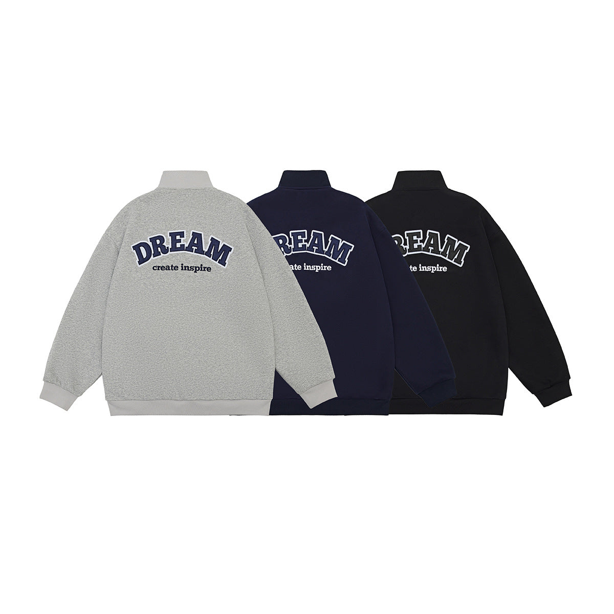 Three back views of the jacket in gray, navy, and black, each with large DREAM lettering.