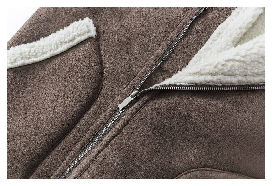 Close-up of the jacket's metal front zipper, brown outer material, and cream fleece lining.