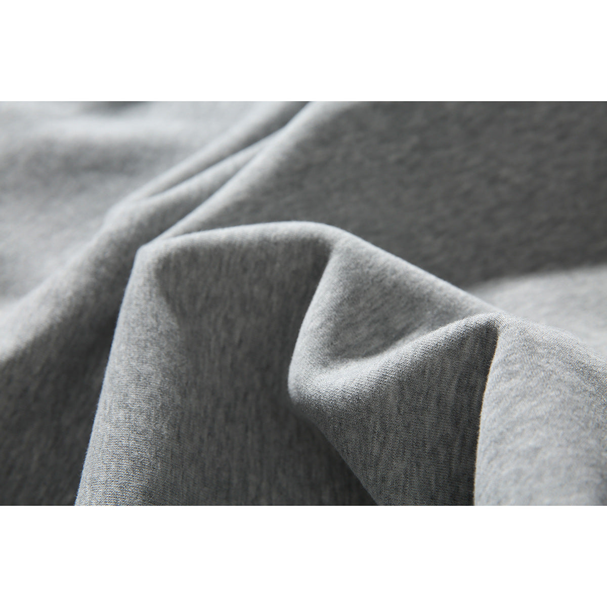 Close-up showing the texture and folds of gray hoodie fabric.