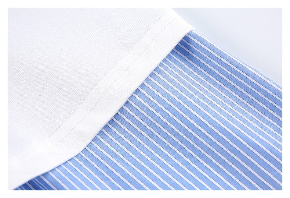 Close-up of white fabric trim overlapping a blue-and-white striped shirt panel.