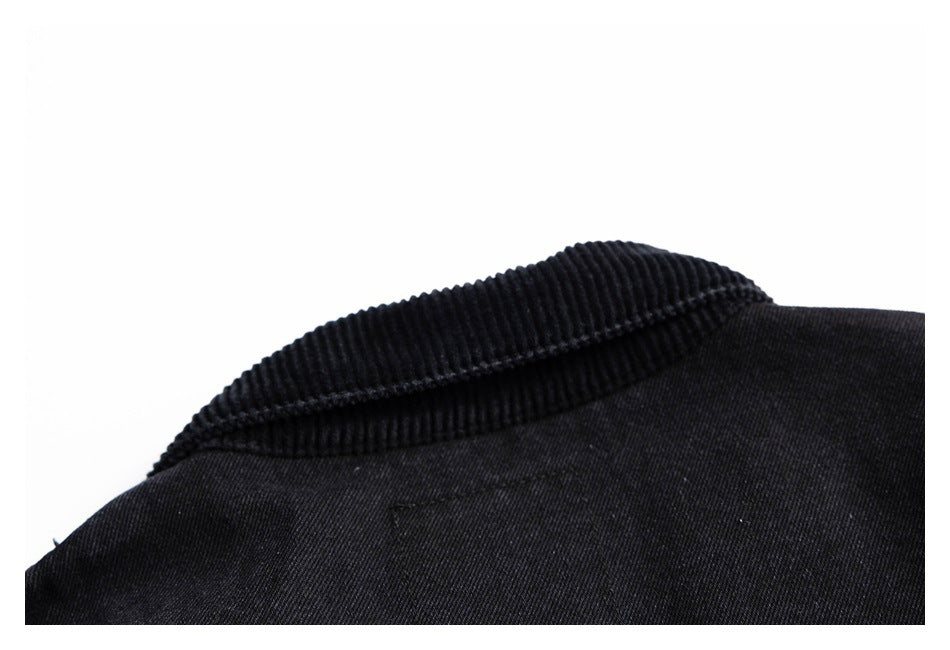 Close-up of a black garment collar with ribbed trim and stitching.