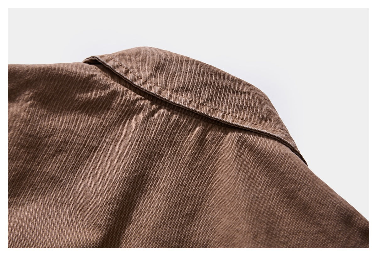 Close-up of a brown textured garment showing the stitched collar and shoulder seam.