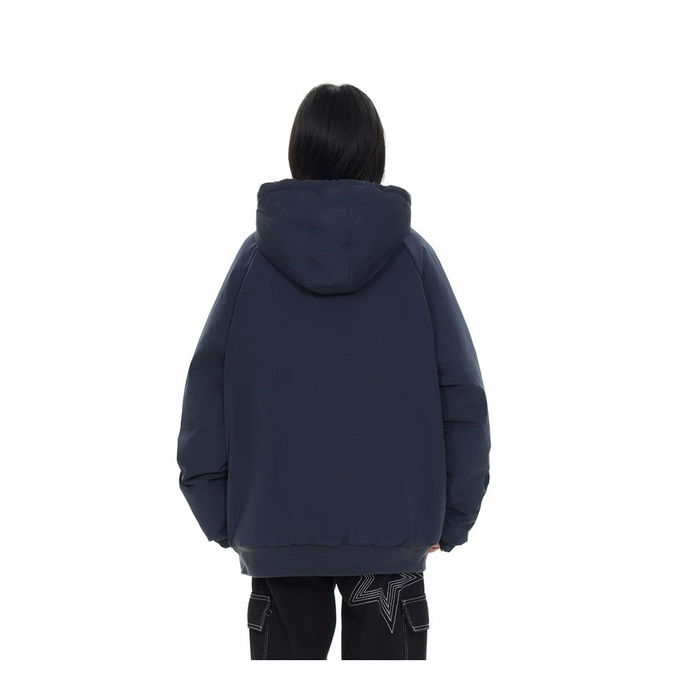 Back view of a model wearing a dark navy hooded jacket with a ribbed hem.