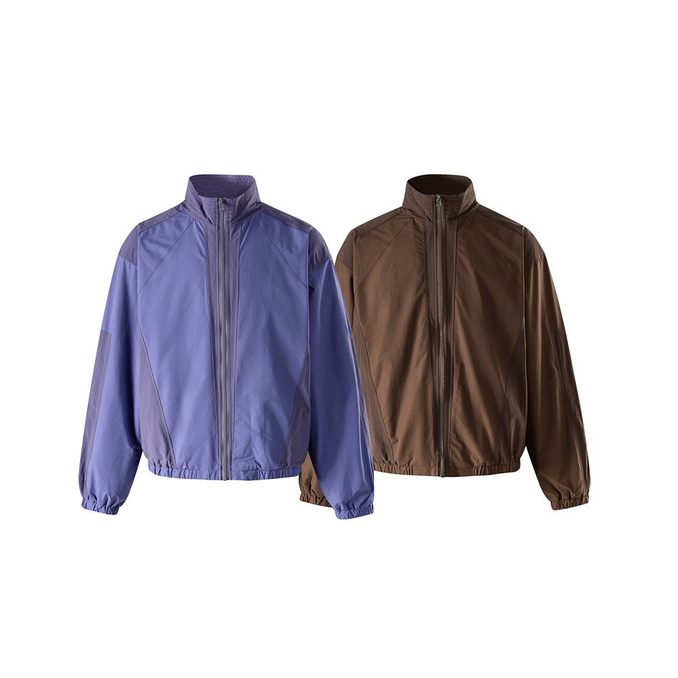 Two front-view zip jackets: one blue-violet with dark contrast panels and one solid brown.