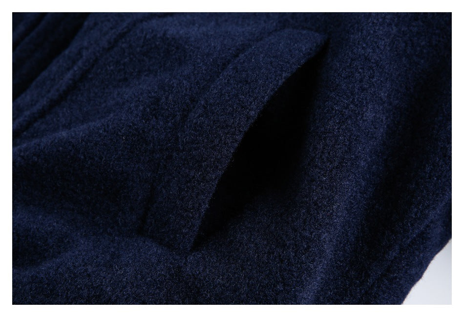 Close-up of dark navy garment fabric with a narrow shadowed opening or fold.
