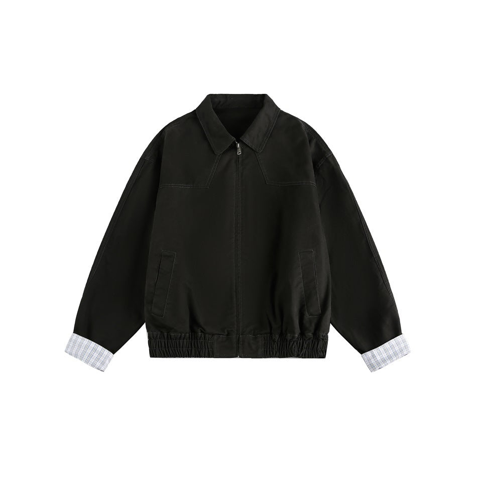 Dark gray zip-front jacket flat lay with collar, front pockets, gathered hem and checked cuff lining