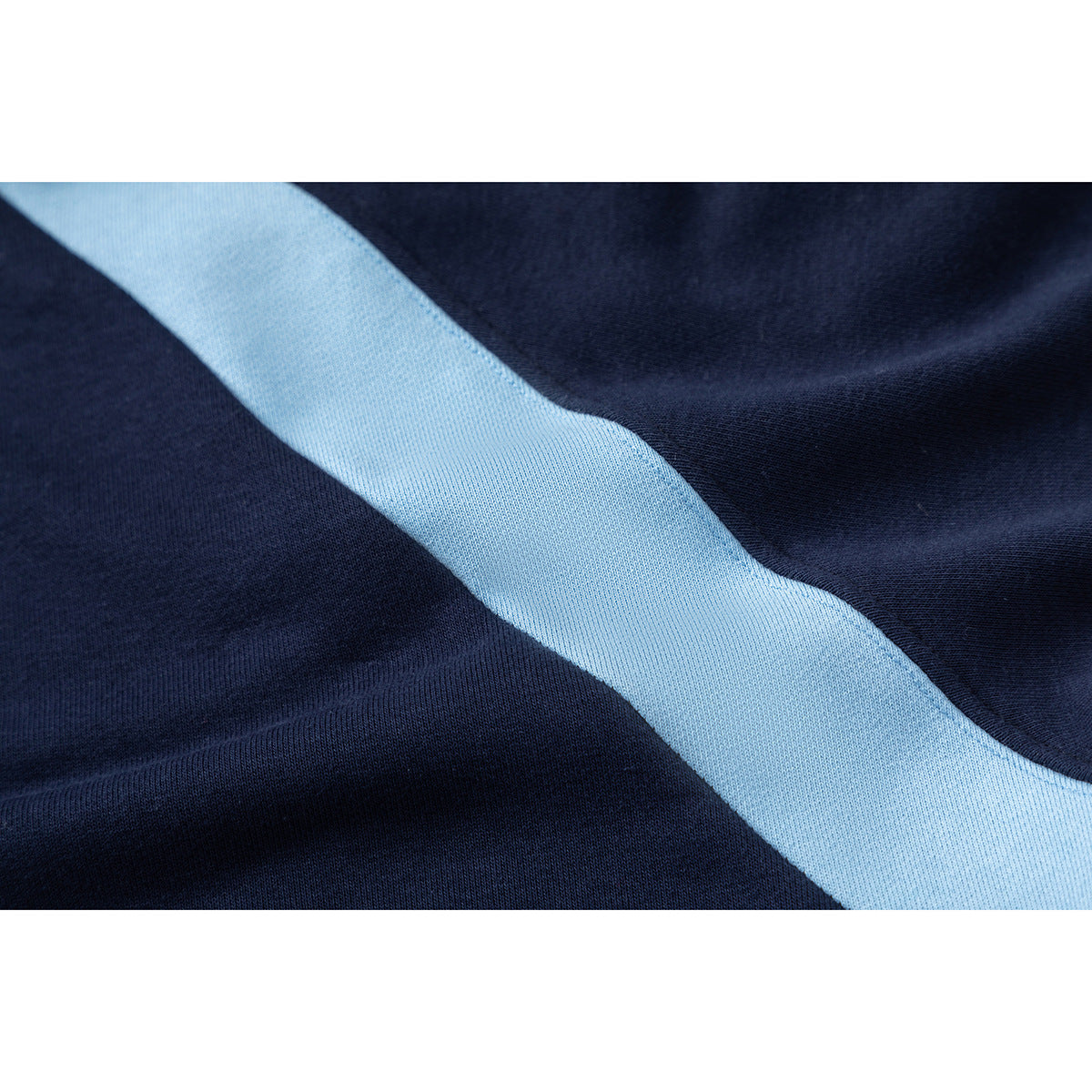 Close-up of navy fabric with a broad light blue stripe.
