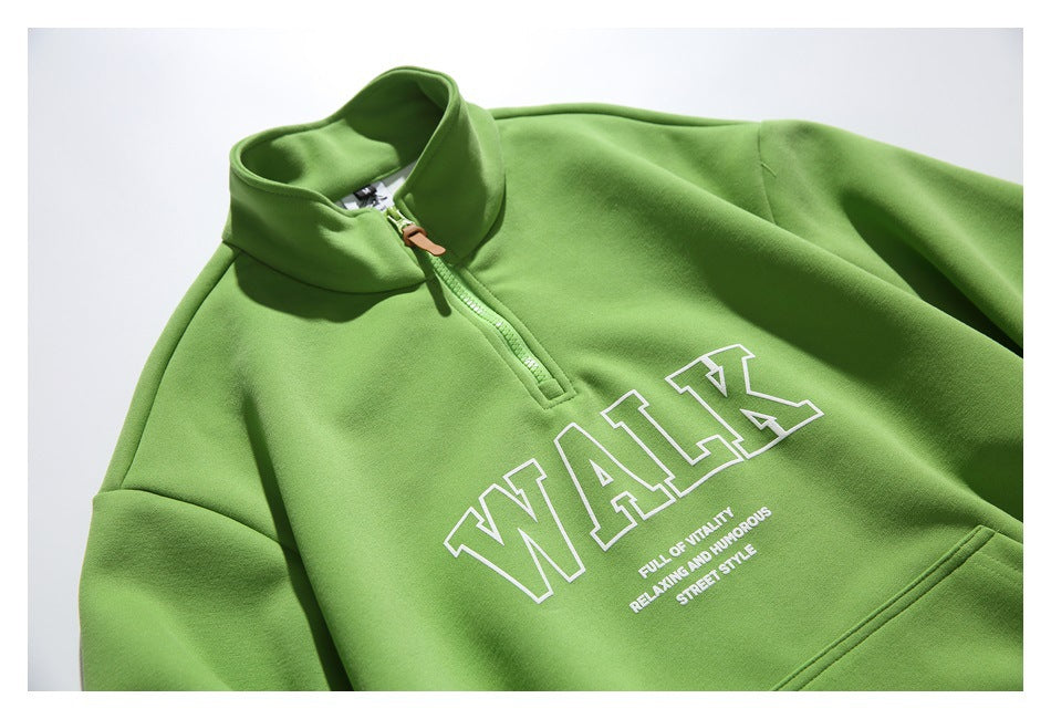 Bright green quarter-zip pullover laid flat, with a stand collar, kangaroo pocket, ribbed cuffs, and white outlined