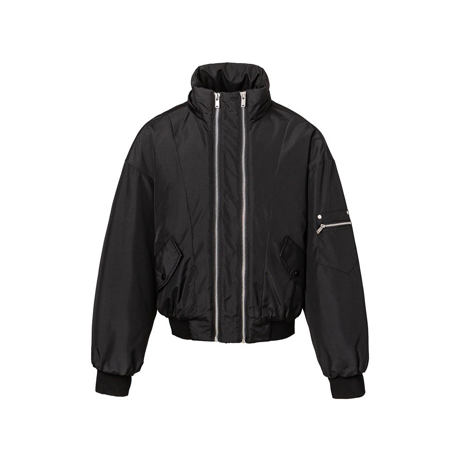 Front view of a black hooded jacket with double silver zippers, flap pockets, and a zippered sleeve pocket.