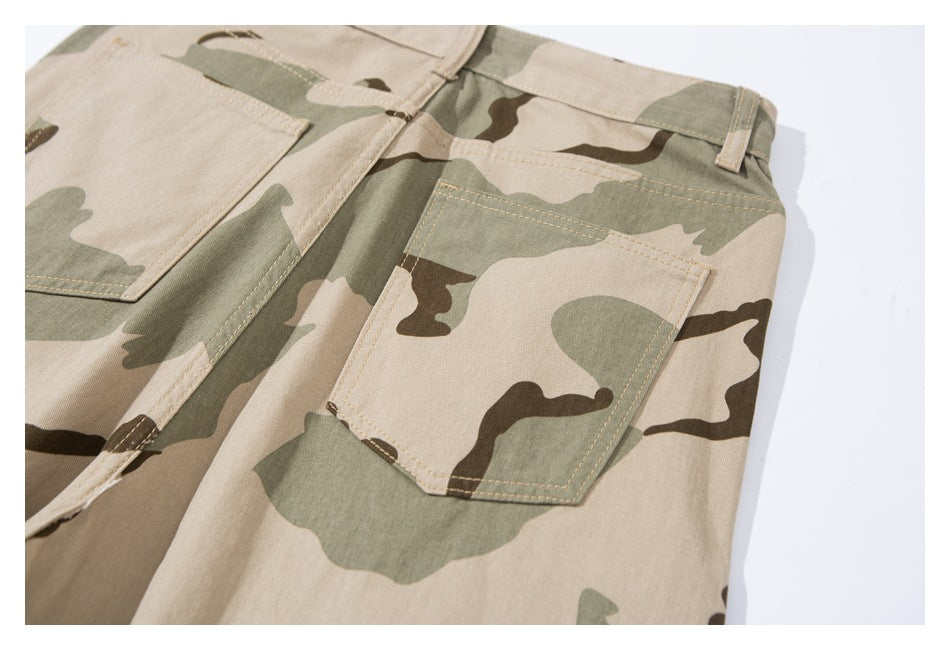 Close-up of camouflage pants showing a rear patch pocket, waistband, belt loop, and stitched seams.