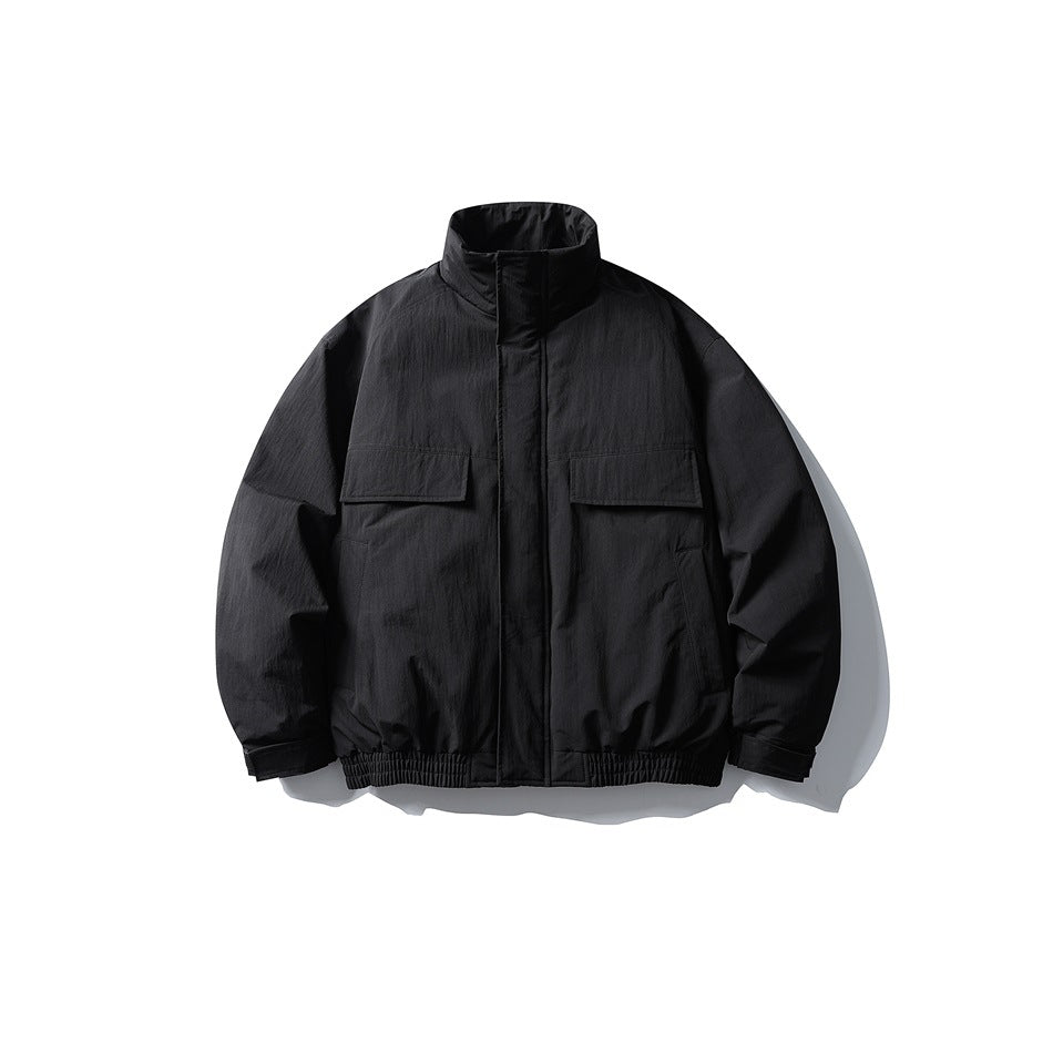 Black stand-collar jacket flat lay, front view, with flap chest pockets and elastic hem