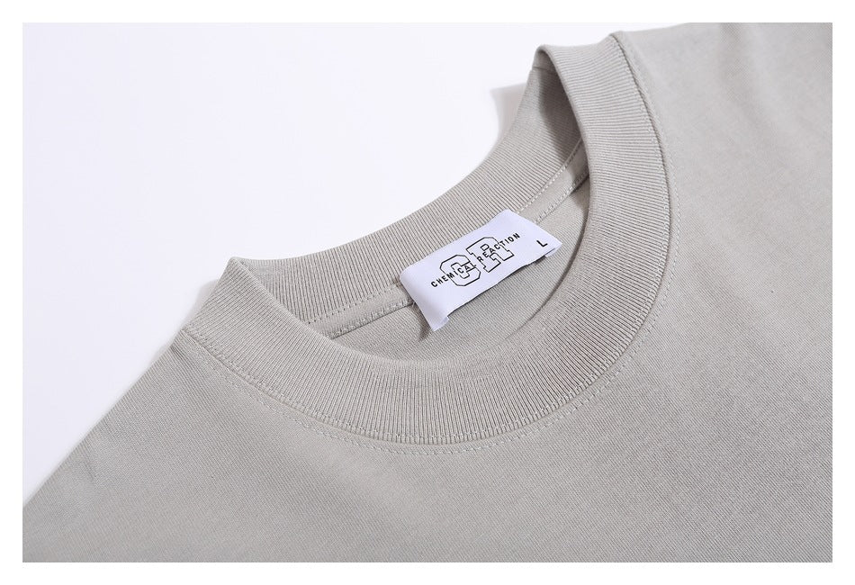 Close-up of a light gray crew neck and interior white label with black lettering.