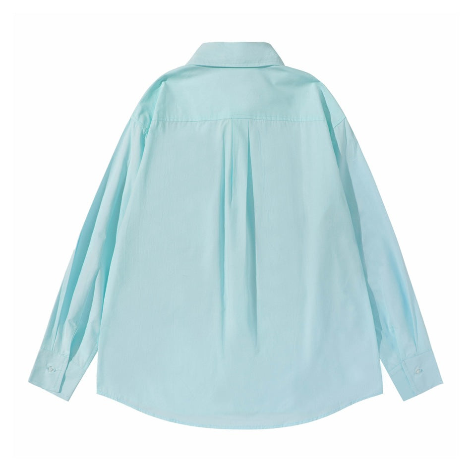 Back view of a light aqua long-sleeve button-up shirt with a pointed collar and center pleat.