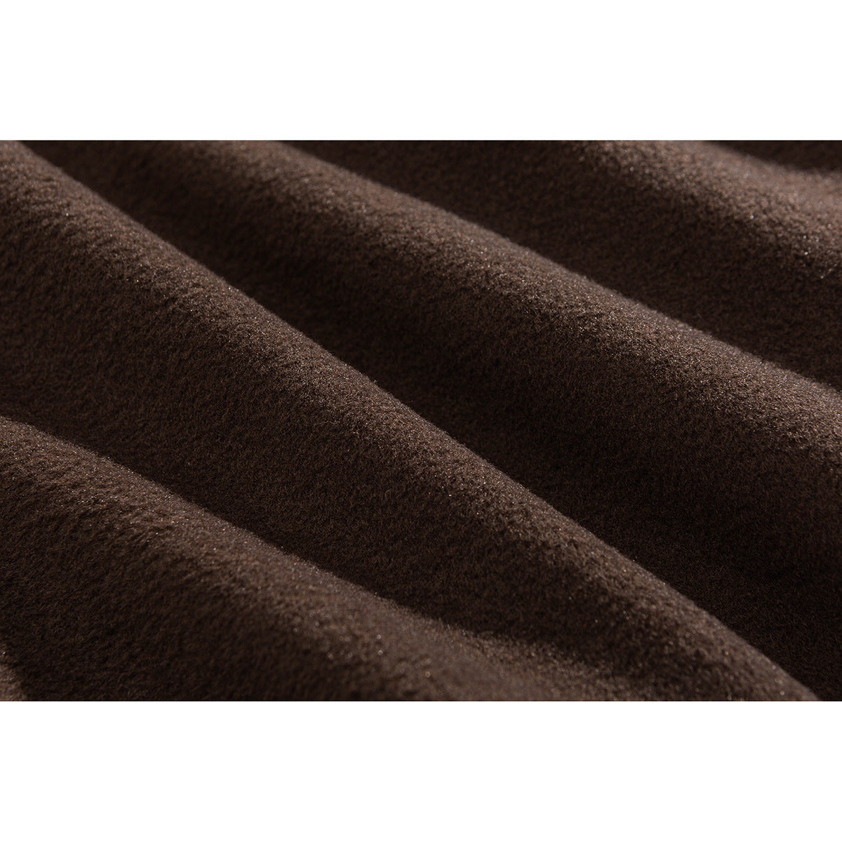 Extreme close-up showing the soft, textured surface of brown coat fabric.