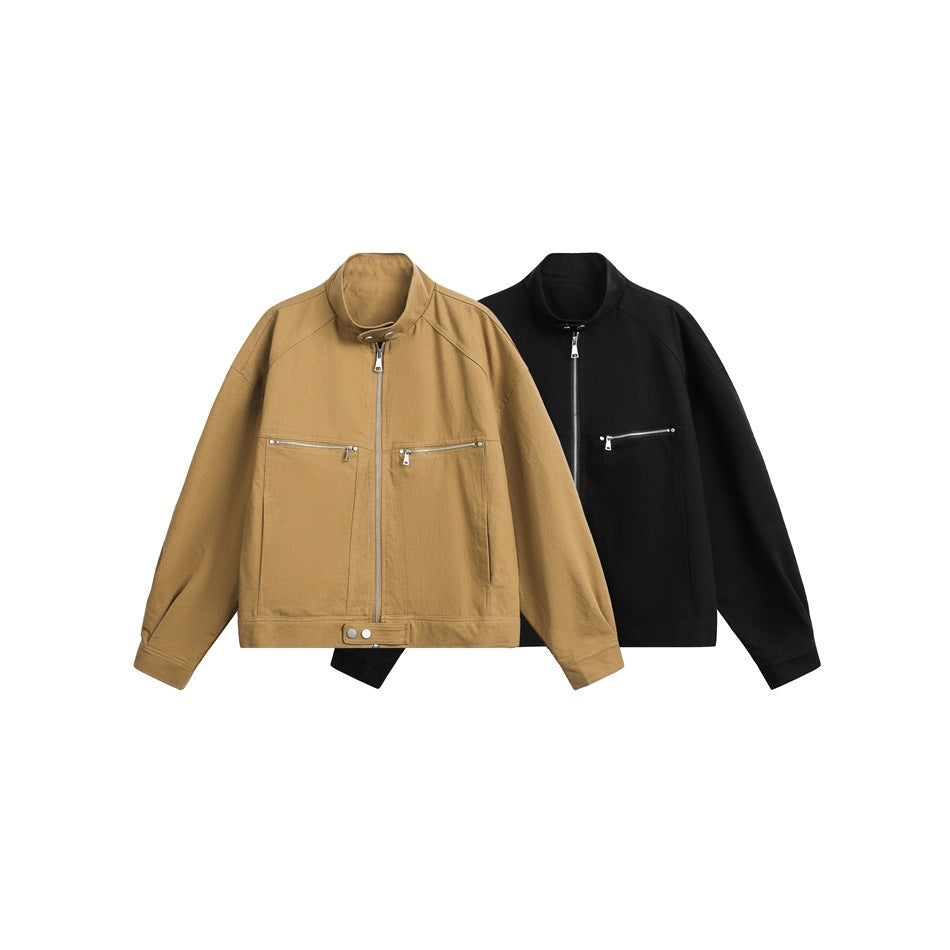 Front view of tan and black stand-collar jackets with zip fronts and horizontal zip chest pockets.