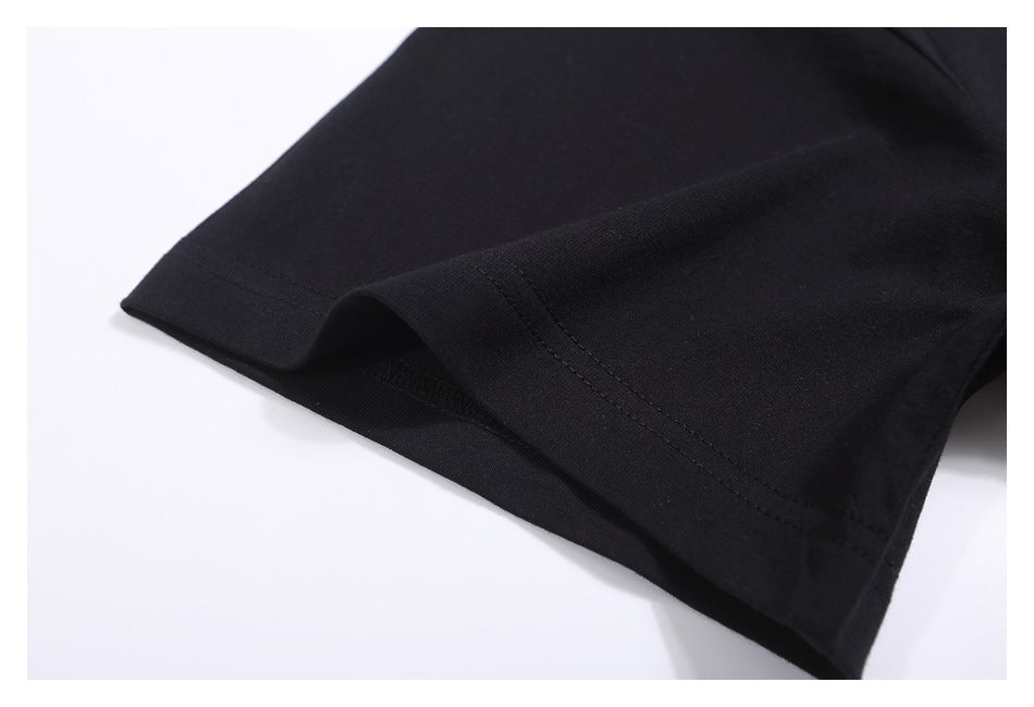 Close-up of the black T-shirt sleeve hem and stitching.
