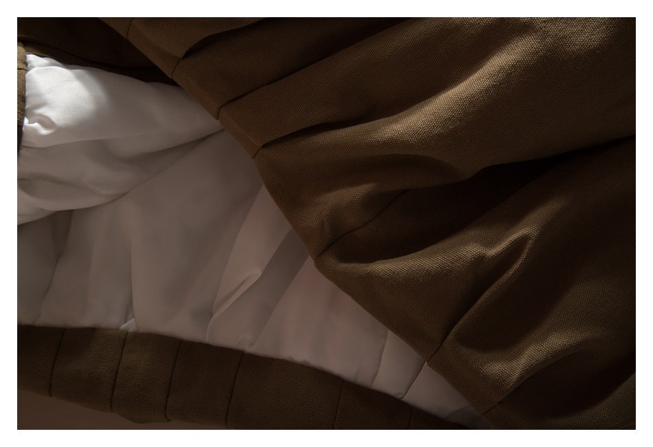 Close-up of a dark brown garment exterior beside its white inner lining.