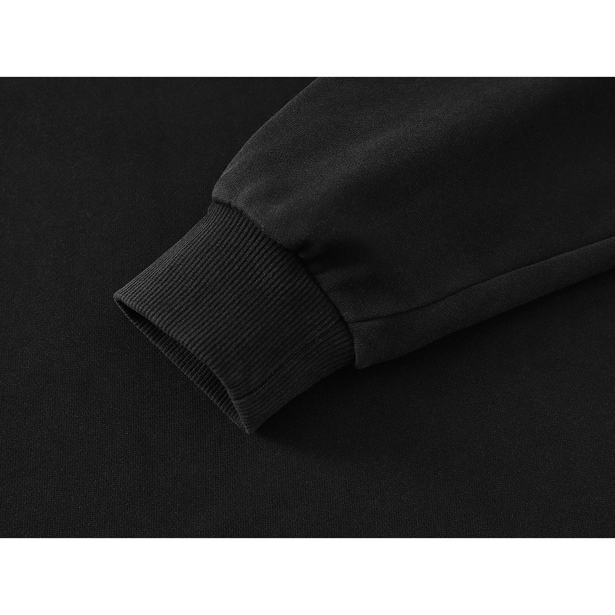 Close-up of a black sweatshirt sleeve ending in a wide ribbed cuff.
