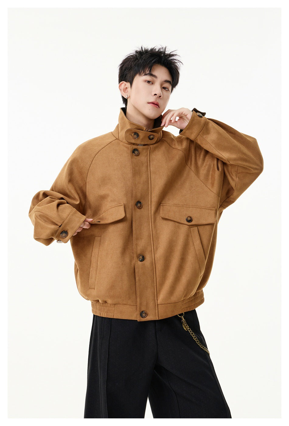 Model wearing a camel-brown jacket fastened to a stand collar, with buttoned flap pockets and a gathered hem.