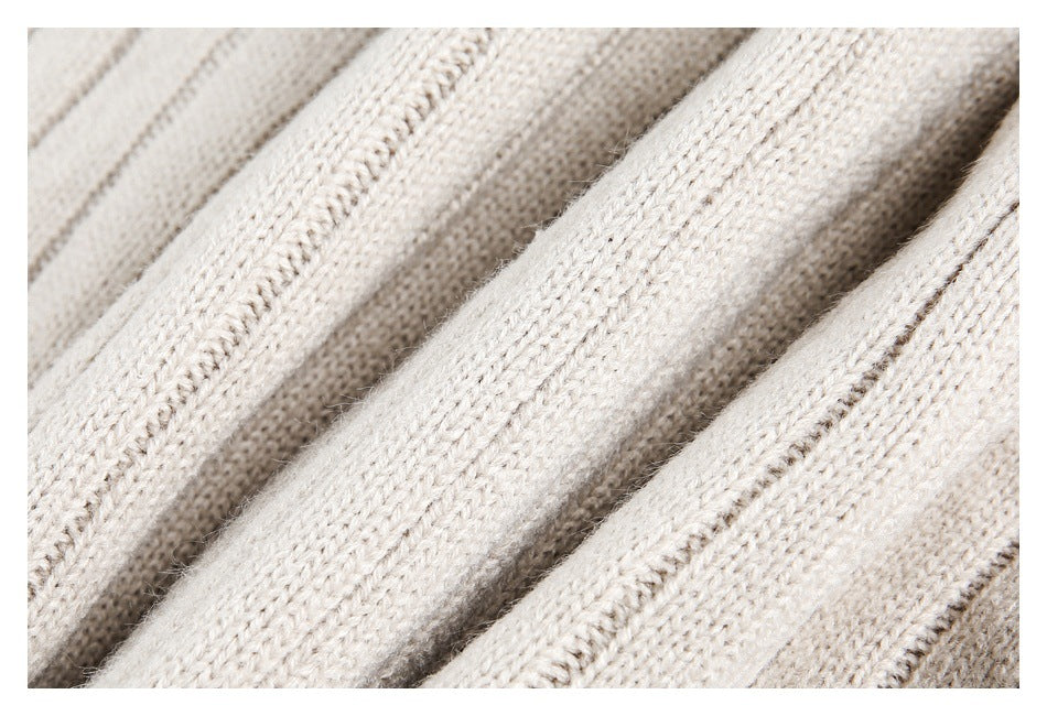 Close-up of ivory knit fabric showing its soft, textured stitches and raised ribs.