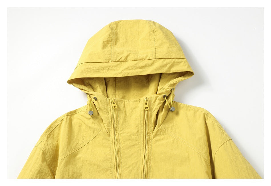 Cropped front view of a yellow hooded jacket with drawcords and two vertical zippers.