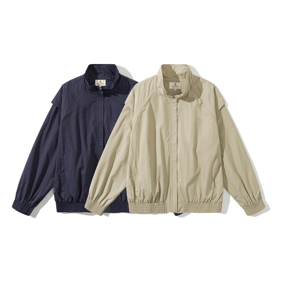 Two stand-collar jackets shown from the front, one navy and one beige, with zip fronts and elastic hems and cuffs.