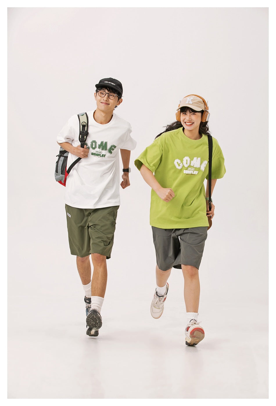 Two models walking in white and lime green oversized graphic T-shirts and casual shorts.
