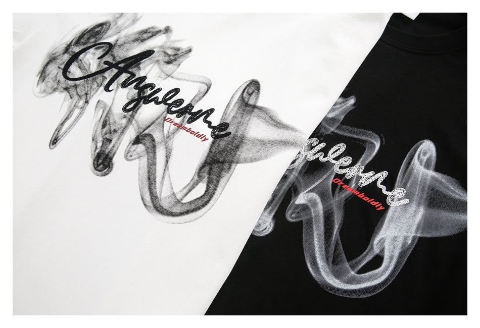 Close-up of white and black T-shirts showing smoky script graphics with small red lettering.