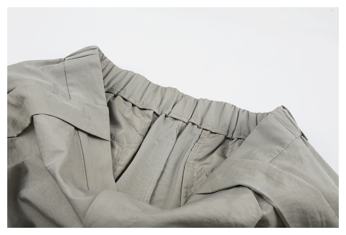 Close-up of the inside waistband and fly area of light gray-beige trousers.