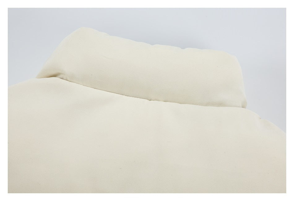 Close-up of cream fabric folded along a stitched seam.