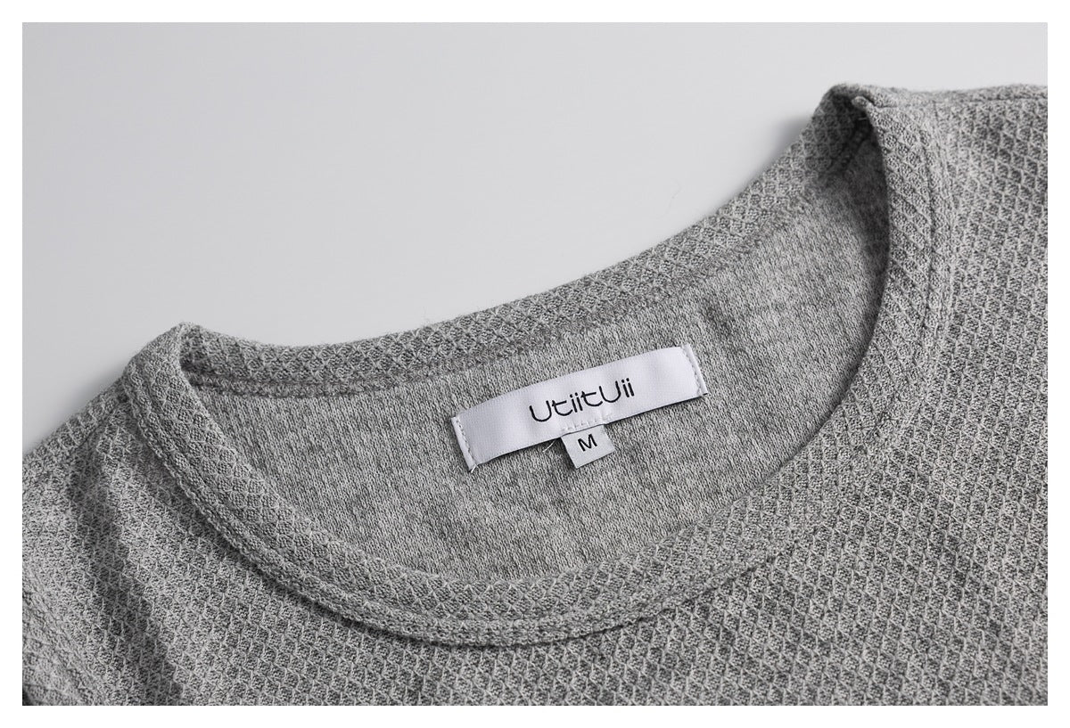 Close-up of the gray textured top's neckline and inner label, marked M.