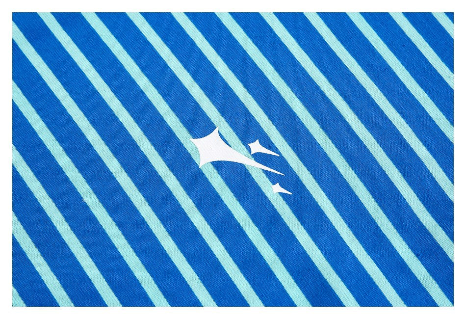 Close-up of blue and pale aqua diagonal stripes with a small white abstract graphic.
