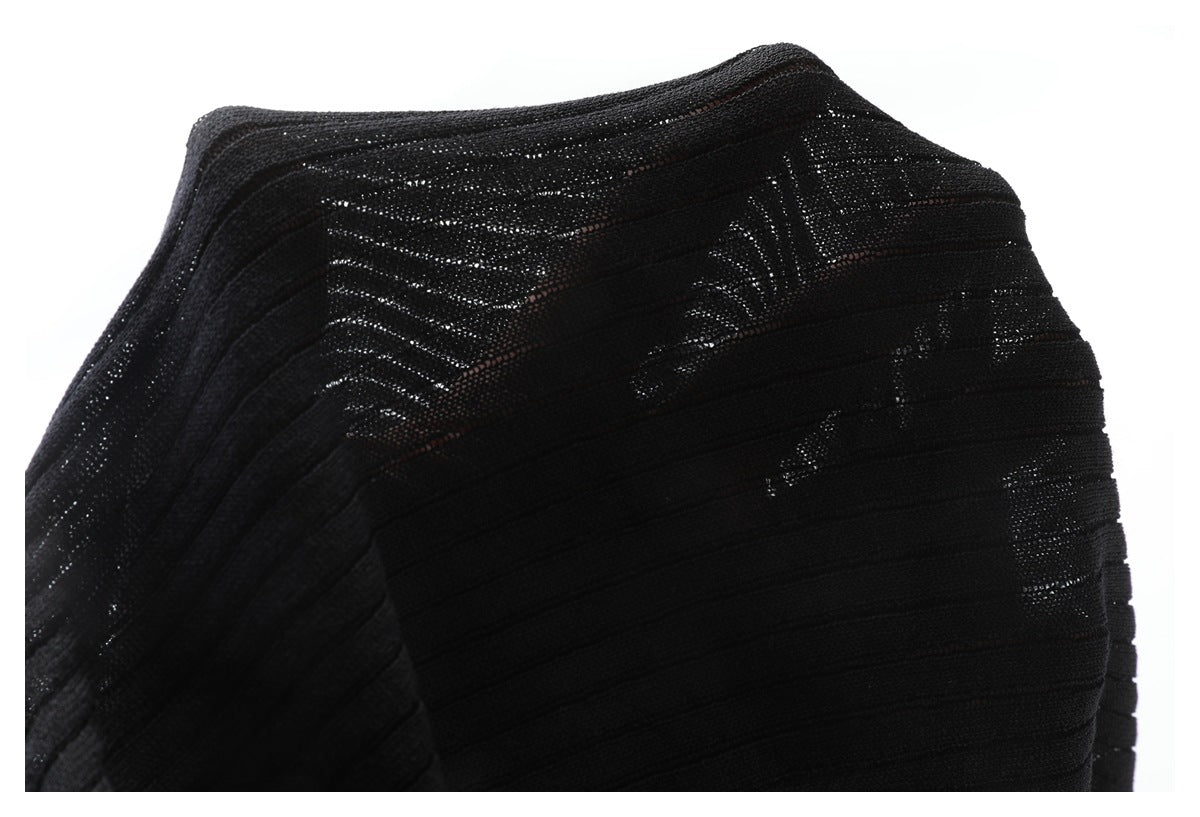 Close-up of a black knit garment panel with horizontal bands and openwork texture.