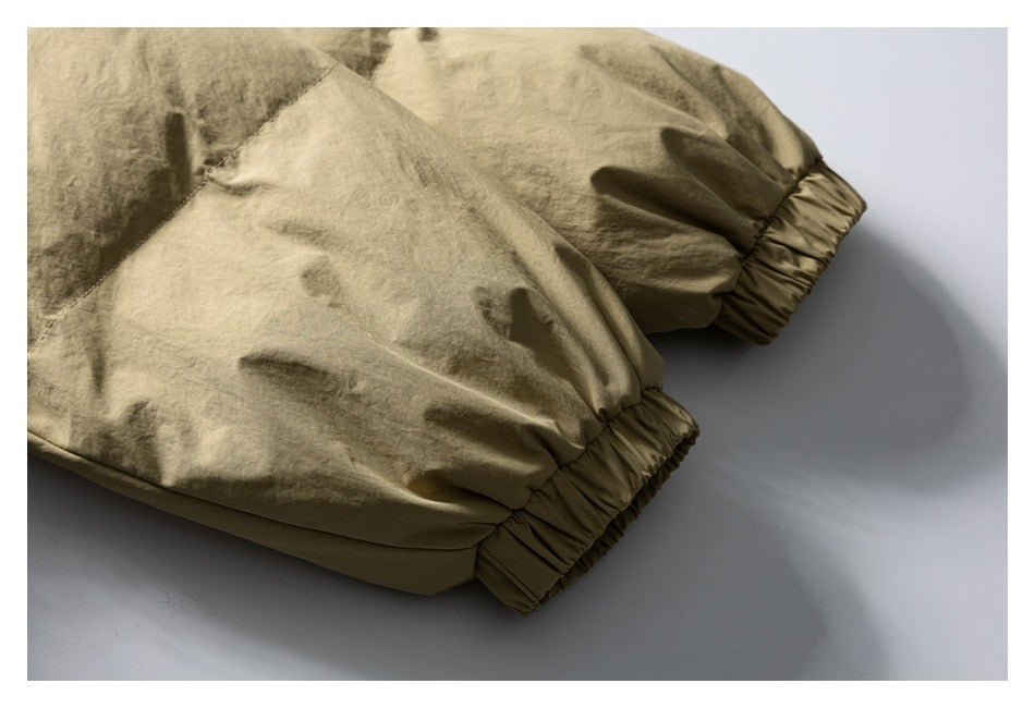Close-up of khaki jacket sleeves finished with gathered elastic cuffs.