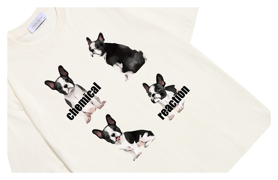 Angled close-up of an ivory T-shirt with four French bulldog illustrations and black “chemical reaction” lettering.