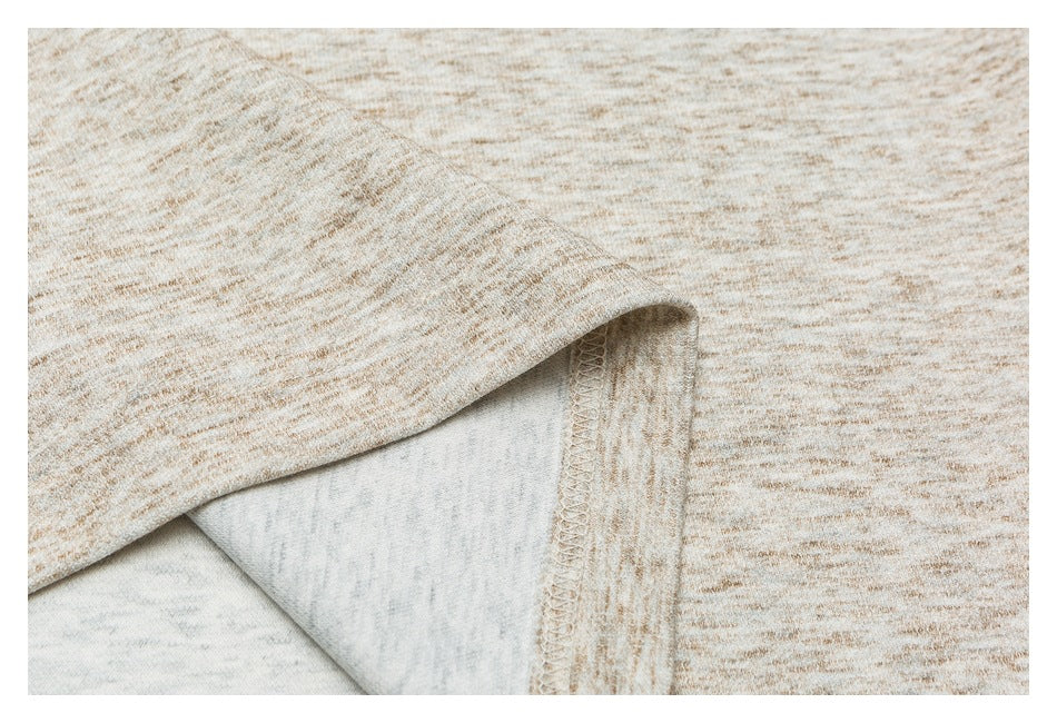 Close-up of a folded garment edge showing the reverse fabric and overlocked seam.