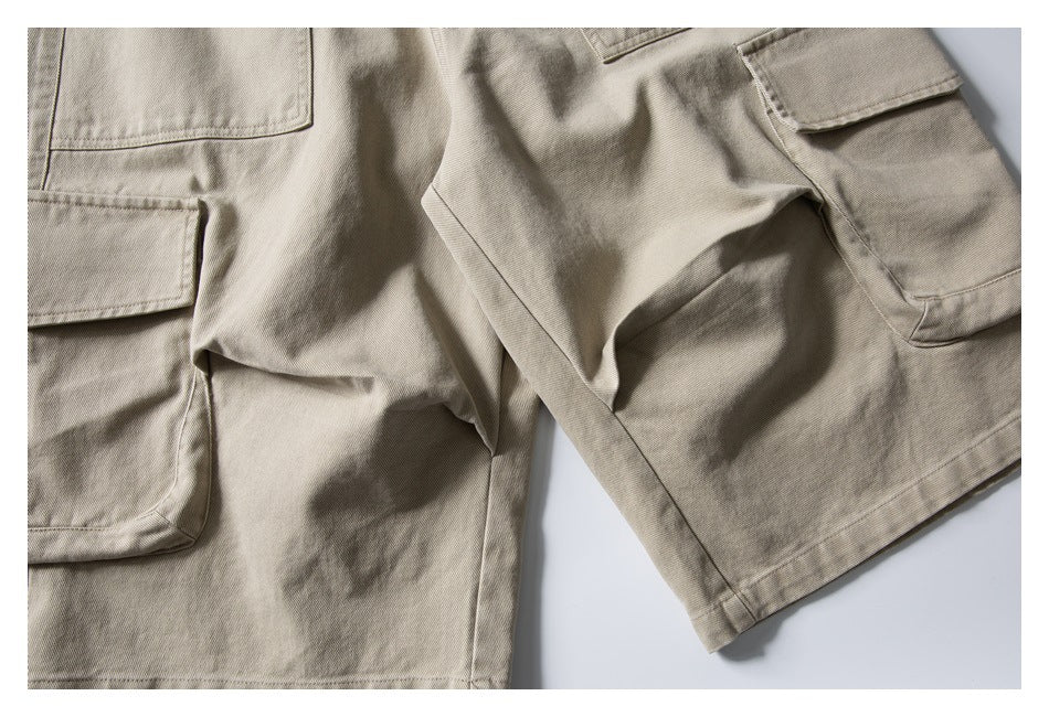 Partial flat lay of beige cargo shorts showing both legs and large flap pockets.
