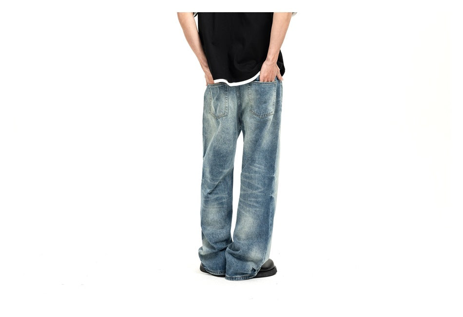 Model wearing light blue, faded wide-leg jeans, shown from waist to shoes against a white background.