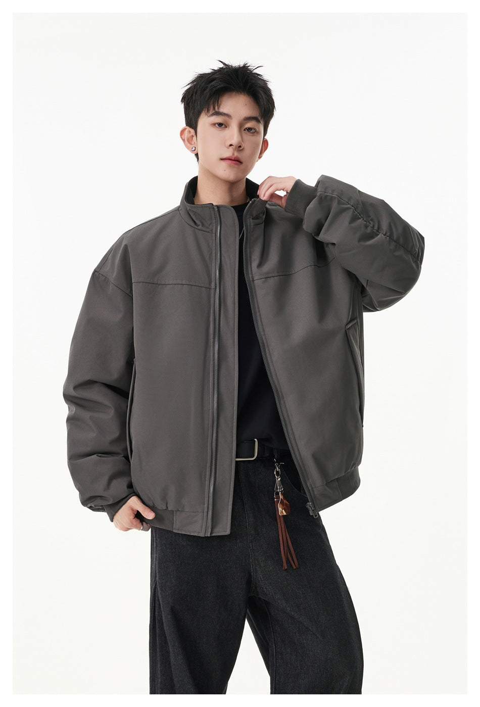 Model wearing a charcoal gray zip-front jacket with a stand collar and roomy sleeves.